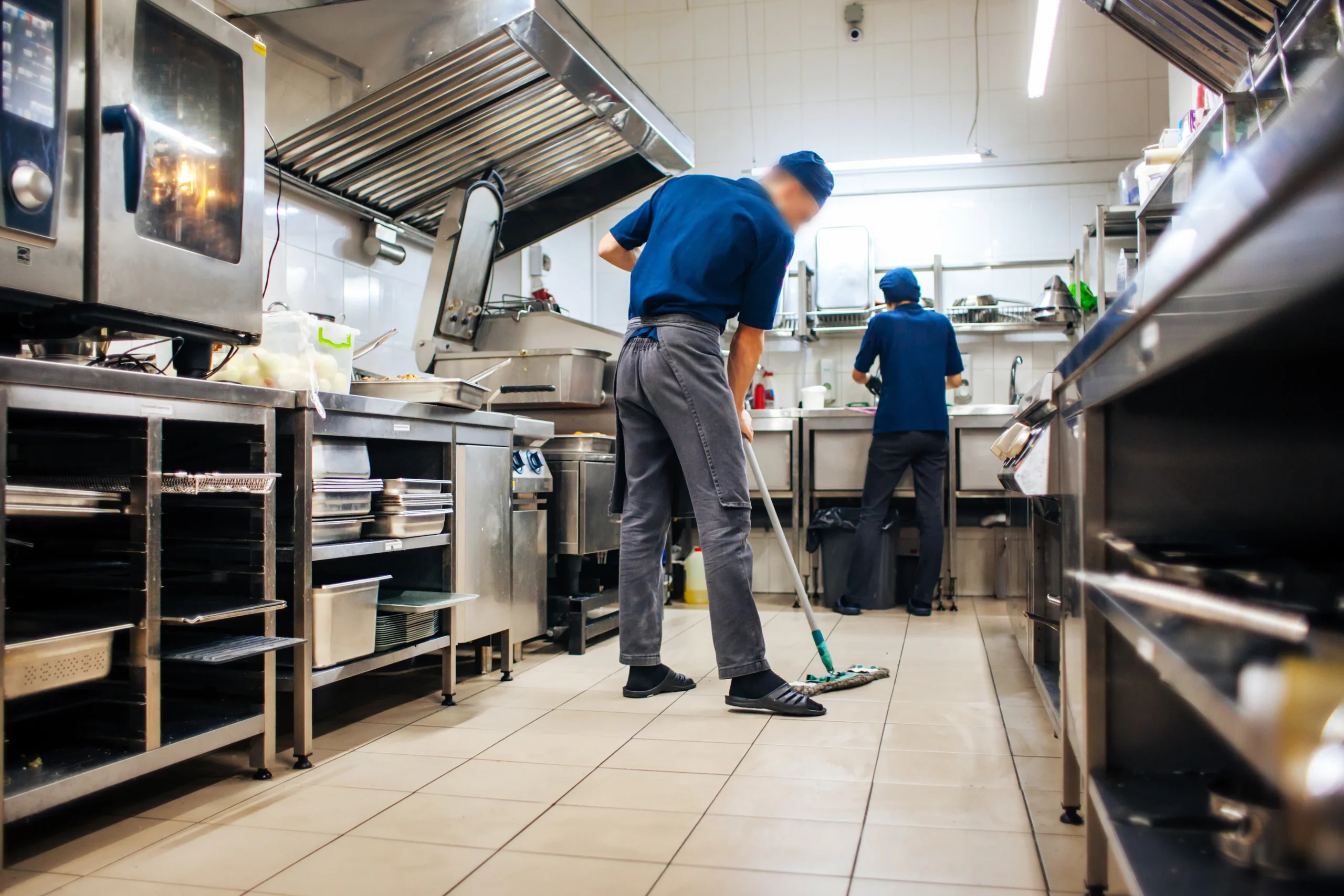 Restaurant Janitor Two men in a kitchen cleaning the floor.